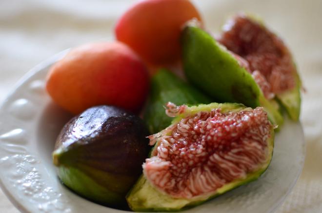 a bowl of figs and apricots